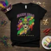 Mardi Gras t-shirt design with a jester mask, crawfish, and colorful brush strokes in purple, green, and gold
