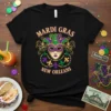 Mardi Gras New Orleans text with a decorative carnival mask and beads graphic on a black t-shirt