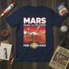 T-shirt design featuring "MARS Ready to COLONIZE FRIED CHICKEN SHACK" text with astronaut looking at Mars landscape and rocket