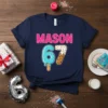 Navy blue t-shirt with "MASON 67" design, featuring pink sprinkles and ice cream-themed numbers