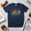 Master Builder text design with colorful block letters and bursting effect, on a navy blue t-shirt