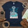 Navy blue t-shirt with "maui" text, anchor, waves, and whales graphic in tribal and ocean-inspired style