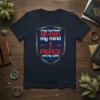 Navy t-shirt featuring a shield graphic with the quote "may my heart BE KIND my mind FIERCE and my spirit"