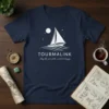 Navy t-shirt with white text "May the Acts of the World Be Happy" and a sailboat graphic under the moon