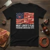Black t-shirt featuring an American flag design made from various meat cuts, with text "MEAT LOVER'S FLAG PREMIUM AMERICAN CUTS"
