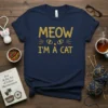 Meow I'm A Cat text design with cat eyes and whiskers on a navy t-shirt