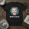 Meow & Relax text with a cute cartoon cat illustration on a black t-shirt, ideal for cat lovers
