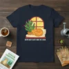 Meow And Plants Make Me Grow t-shirt featuring a sleeping cat next to a potted cactus by a window