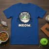 MEOW. T-Shirt design featuring a cute cartoon grey and white cat face with green eyes and the text MEOW
