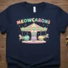 Meowcarons t-shirt design with cute cats on a carousel, pastel colors, music notes, and stars