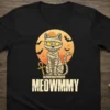 Meowmmy mummy cat Halloween t-shirt design with Egyptian ankh symbol and bats against a moon