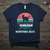 Meowtronic Beats t-shirt design featuring a black cat standing on a synthesizer keyboard with a retro sunset background