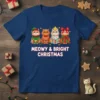 Meowy & Bright Christmas text with four festive cats on a navy blue t-shirt, featuring elf, gingerbread, Christmas lights, and