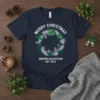 Merry Christmas Winter Collection Est 2023 text on a navy t-shirt with a festive wreath graphic