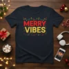 Merry Vibes Christmas T-Shirt with festive lights and musical notes graphic