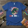 MERWRCA patriotic T-Rex dinosaur graphic with American flag shield and fireworks on a blue t-shirt