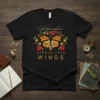 Black t-shirt with "Metamorphosis Spread Your Wings" text and a monarch butterfly surrounded by flowers design
