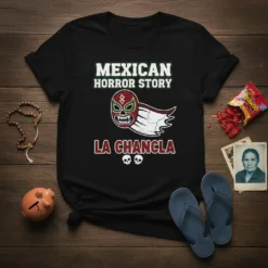 Black t-shirt with "Mexican Horror Story La Chancla" text and a lucha libre mask graphic with wings and skulls