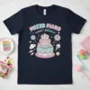 Mezzo Piano Sweet Delicious text with a cute three-tier cake, lollipops, and candy graphic on a navy t-shirt