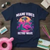 Miami Vibes Retro Wave t-shirt with a pink flamingo wearing sunglasses and a hat, set against a retro cityscape and