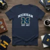 Navy t-shirt with "MICHIGAN EST. 1817" in white and yellow text above a large block "M" containing the outline of
