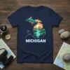 Michigan state map graphic t-shirt featuring a scenic landscape, bridge, deer, and the text MICHIGAN