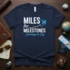 Miles for Milestones Journeys to Joy quote on a navy blue t-shirt with an airplane and heart graphic