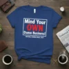 Mind Your OWN Damn Business! Walz Harris 2024 t-shirt design with bold white and red text in a rectangular frame