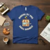 Minding My Own Small Business quote with a cute bee and storefront graphic on a navy t-shirt