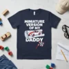 Miniature Version Of My Daddy text with a racing car graphic and checkered flag on a navy t-shirt