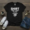 Black t-shirt with bold white text 'SHIRT' above a grey graphic of a hanger with a garment