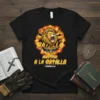 Ministerio a la Batalla Christian Lion T-Shirt with 1 Timoteo 6:12 verse, featuring a golden lion and flames