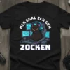 Black t-shirt with "Mir Egal Ich Geh Zocken" text above a cartoon black cat wearing headphones and sitting at a