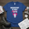 Misogyny Is Not Cute feminist quote t-shirt with a broken heart and raised fist graphic
