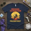 Mission: Extraction Phlebotomist t-shirt with a silhouette climbing with a syringe against a sunset graphic
