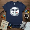 MIT Mom in Training text with baby bottle, graduation cap, and coffee cup graphic on a navy t-shirt