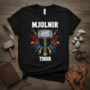 Black t-shirt with white text 'MJOLNIR THOR' above an illustration of Thor's hammer, Mjolnir, surrounded by colorful lightning bolts