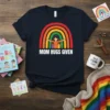 Navy t-shirt with "Mom Hugs Given" text and a rainbow graphic featuring a mother hugging two children