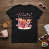Black t-shirt with "Mom Juice" text in pink script, surrounded by colorful floral cans and star graphics