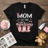 Mom Of The Notorious O.N.E text with crown and stars on a black t-shirt, celebrating a first birthday