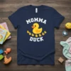 Navy blue t-shirt with "Momma Duck" text above a large yellow duckling and smaller ducklings, Momma Duck graphic tee