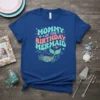 Mommy Of The Birthday Mermaid text with a mermaid tail graphic on a blue t-shirt