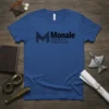 Monale Ascension Chronicles text logo on a blue t-shirt, with a stylized M graphic