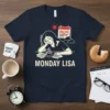 MONDAY LISA text on a navy t-shirt with a graphic of a tired woman at a desk and a calendar