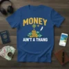 Money Ain't A Thang t-shirt with stacks of cash, coins, hot air balloon, and feather graphic