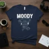 Moody Tornado Coffee T-Shirt featuring a grumpy tornado graphic and a spilled coffee cup, with the word MOODY in bold
