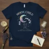 Moon Child t-shirt with pastel crescent moon, stars, and moon phases, featuring a silhouette of a person holding a staff