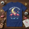 Moonlight Melody Makers text above three singing flamingos with a moon and musical notes graphic on a navy t-shirt