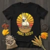 More Seed? text with a cartoon cockatoo and a bowl of seeds design on a black t-shirt