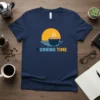 MORNING TIME text with a steaming coffee cup and sunrise graphic on a navy blue t-shirt